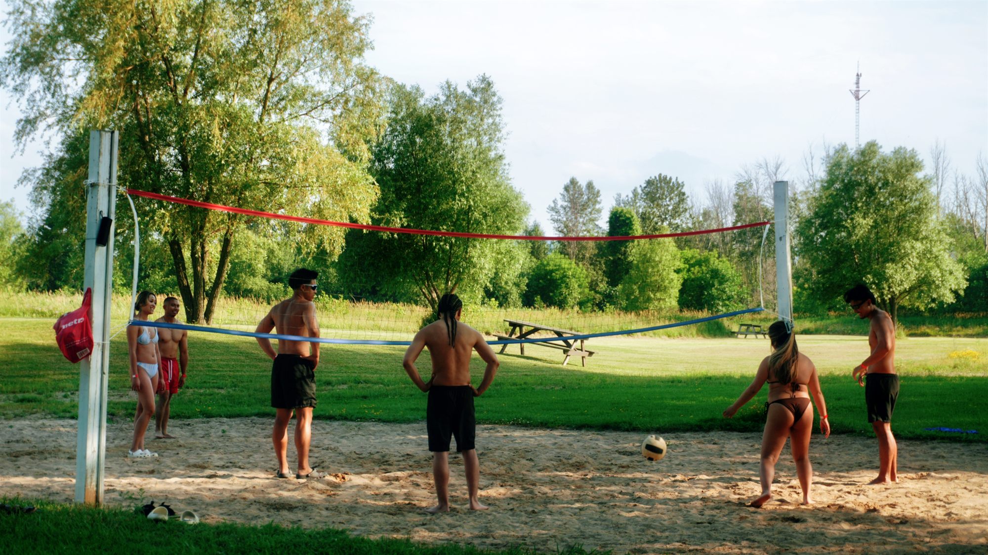 A group playing beach volleyball on the sand court at the private Georgian Bay shoreline